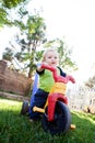 Baby boy riding on a toy