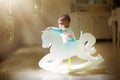 Baby boy on rocking horse. Nursery toy Royalty Free Stock Photo