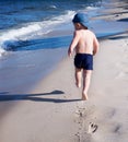 Baby boy running on beach, sea. Royalty Free Stock Photo