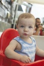 Baby boy seated in high chair at terrace restaurant Royalty Free Stock Photo