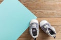 Baby boy shoes on pastel blue and wooden background Royalty Free Stock Photo