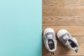 Baby boy shoes on pastel blue and wooden background Royalty Free Stock Photo