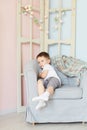 Baby boy sitting on a chair in the room