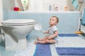 Baby boy sitting on floor at bathroom Royalty Free Stock Photo