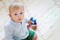 Baby boy sitting on floor and holding toy car Royalty Free Stock Photo