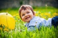 Baby boy sitting on the grass in field Royalty Free Stock Photo