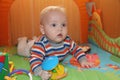 Baby boy sitting in the orange playpen Royalty Free Stock Photo
