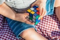 Baby Boy Sitting on Picnic Blanket Playing With Cube Puzzle Toy