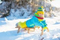 Baby boy on sled. Child sledding. Kid with sledge Royalty Free Stock Photo