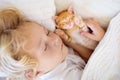 Baby boy sleeping with kitten. Child and cat Royalty Free Stock Photo