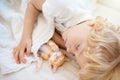 Baby boy sleeping with kitten. Child and cat Royalty Free Stock Photo