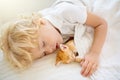 Baby boy sleeping with kitten. Child and cat Royalty Free Stock Photo