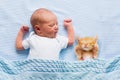 Baby boy sleeping with kitten. Child and cat