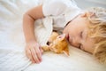 Baby boy sleeping with kitten. Child and cat Royalty Free Stock Photo