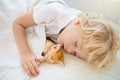 Baby boy sleeping with kitten. Child and cat Royalty Free Stock Photo