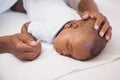 Baby boy sleeping peacefully on couch with father Royalty Free Stock Photo