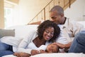 Baby boy sleeping peacefully on couch with happy parents Royalty Free Stock Photo