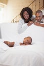 Baby boy sleeping peacefully on couch watched by parents Royalty Free Stock Photo