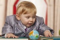 Baby boy with small globe Royalty Free Stock Photo