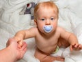 Baby boy with soother stands up Royalty Free Stock Photo