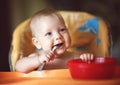 Baby boy spoon eats itself