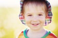 Baby boy standing in grass on the fieald with dandelions Royalty Free Stock Photo