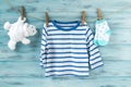 Baby boy striped shirt, socks with stars and white toy bear on a clothesline Royalty Free Stock Photo