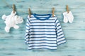 Baby boy striped shirt, socks and white toy bear on a clothesline Royalty Free Stock Photo