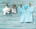 Baby boy t-shirt, socks and white toy bear on a clothesline Royalty Free Stock Photo