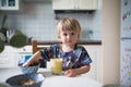 Baby boy toddler have breakfast at home and drinking smooth