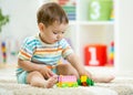 Baby toddler playing wooden toys at home Royalty Free Stock Photo