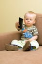 Baby boy with TV remote Royalty Free Stock Photo