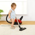 Baby boy with vacuum cleaner Royalty Free Stock Photo