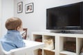 Baby boy watching television in living room Royalty Free Stock Photo