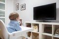 Baby boy watching television in living room Royalty Free Stock Photo