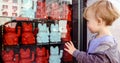 Baby boy waving hand while watching Maneki neko