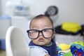 A baby boy is wearing a pair of eye glasses Royalty Free Stock Photo