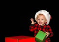 Baby boy wearing a Santa hat smiling holding Christmas presents Royalty Free Stock Photo