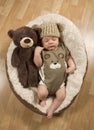 Baby Boy Wearing A Teddy Bear Hat and Romper