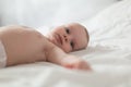 Baby boy in white sunny bedroom