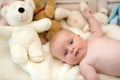 Baby boy and white teddy bear. Childhood and curiosity concept.