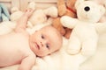 Baby boy and white teddy bear. Childhood and curiosity concept.