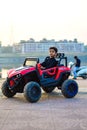 A baby boy who`s name is Raad playing in a electrical toy car