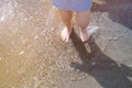 Baby boy& x27;s feet on the sand of the sea beach. Child on sea shore. Baby boy& x27;s feet in sea tide waves. Summer holidays