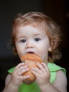 Baby with bread. Cute toddler child eating sandwich, self feeding concept. Royalty Free Stock Photo