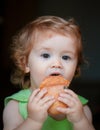 Baby with bread. Cute toddler child eating sandwich, self feeding concept. Royalty Free Stock Photo