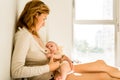 Baby breastfed by his mother in bed quiet in the morning, healthy motherhood concept Royalty Free Stock Photo