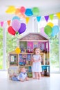 Baby brother and sister playing with a doll house Royalty Free Stock Photo