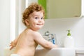 Baby brushing teeth in bathroom Royalty Free Stock Photo