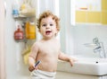 Baby brushing teeth in bathroom Royalty Free Stock Photo
